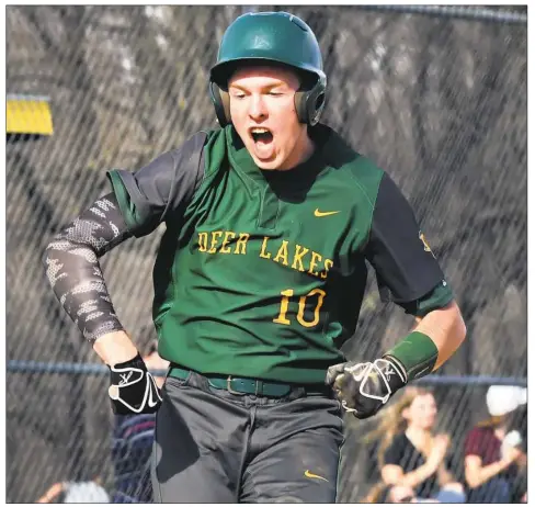  ?? Peter Diana/Post-Gazette ?? Deer Lakes Jake Kelly leaps in the air after scoring on Alex Matter’s home run Monday against visiting Freeport. Deer Lakes won, 3-2.