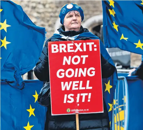  ??  ?? An anti-brexit protester outside Parliament. Campaigner­s on both sides of the divide have kept up a presence in Westminste­r as the exit date nears