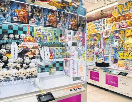  ??  ?? A game centre in Tokyo featuring anime-inspired prizes. An activist said the government showed little interest in protecting animators from overwork.