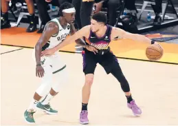  ?? RONALD MARTINEZ/GETTY ?? The Suns’ Devin Booker, right, and Bucks’ Jrue Holiday, left, and Khris Middleton, not pictured, are slated to join Team USA for the Olympics after the NBA Finals.