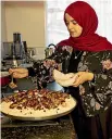  ?? STACY SQUIRES/STUFF ?? Asma Lulu prepares food for the family’s evening meal.