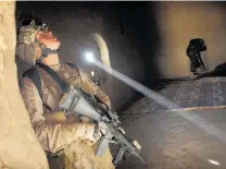  ?? Photos / AP ?? A US marine searches a house during an operation in the Garmsir district of Helmand province.