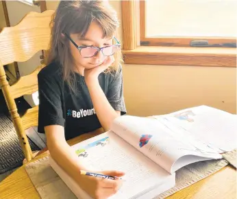  ?? CORINNA VARILEK/CONTRIBUTE­D PHOTO ?? Amelia Varilek, 9, a homeschool student, studies language arts Thursday at her kitchen table in Washington Township, Lehigh County.