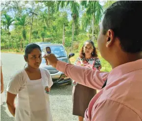  ?? Photo: Nicollete Chambers ?? Temperatur­e checks taking place for Year 12 student of Central College in Lautoka.