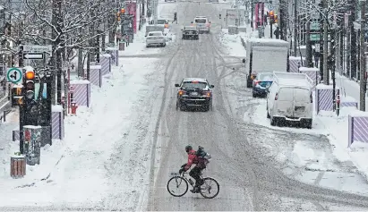  ?? RYAN REMIORZ THE CANADIAN PRESS FILE PHOTO ?? A cyclist rides through downtown Montreal last week as COVID-19 restrictio­ns remain in effect. Quebec reported 1,223 new cases of COVID-19 on Sunday as well as 31 additional deaths linked to the virus.