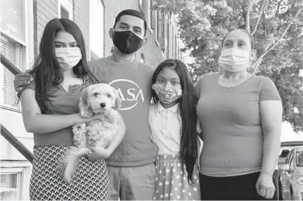  ?? ULYSSES MUÑOZ/BALTIMORE SUN ?? Gamal Karin Martinez, center left, stands with his family in their neighborho­od. From left, his daughters Marvella Martinez (holding their dog Win Dixy) and Dallana Martinez, and his wife, Johana Castillo. Many Maryland renters and families face the threat of eviction.