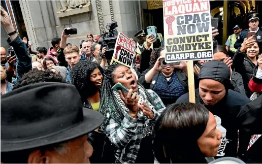  ?? AP ?? People react outside of City Hall after a jury convicted white Chicago police Officer Jason Van Dyke of second-degree murder in the 2014 shooting of black teenager Laquan Mcdonald.