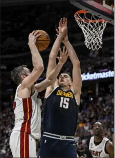  ?? AARON ONTIVEROZ — THE DENVER POST ?? Denver’s Nikola Jokic (15) defends Miami’s Kevin Love during Game 2 of the NBA Finals at Ball Arena.
