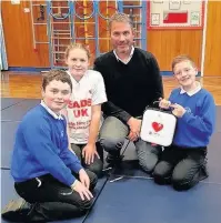  ??  ?? After a successful fund-raising campaign, East Leake’s Brookside Primary School have been successful in getting the £2,000 for their own defibrilla­tor on their school site. Pictured is Gary Kenny, the school headmaster and pupils, showing off the...