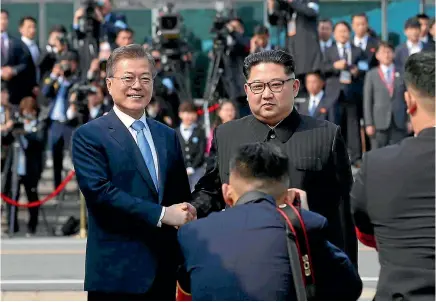  ?? PHOTO: AP ?? North Korean leader Kim Jong Un, right, poses with South Korean President Moon Jae In for the cameras at the border village of Panmunjom in the Demilitari­sed Zone between the two nations.