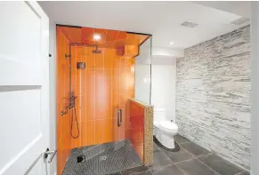  ?? — THE HOLMES GROUP ?? Adding a curbless shower can help maximize space in a bathroom and increase accessibil­ity.
