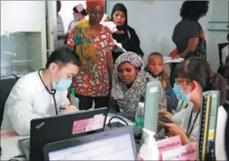  ?? LI SIBO / XINHUA ?? Chinese doctors treat local patients on the naval hospital ship Peace Ark at the port of Dar es Salaam, the economic capital of Tanzania in East Africa, on Nov 21.