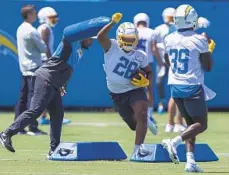  ?? ALEX GALLARDO AP ?? Los Angeles Chargers running back Isaiah Spiller (28) takes part in drills at the team’s practice facility Tuesday in Costa Mesa.