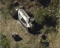  ?? TEL ?? In this aerial image take from video provided by KABC-TV, a vehicle rest on its side after a rollover accident involving golfer Tiger Woods along a road in the Rancho Palos Verdes suburb of Los Angeles on Tuesday. Woods had to be extricated from the vehicle with the “jaws of life” tools, the Los Angeles County Sheriff’s Department said in a statement. Woods was taken to the hospital with unspecifie­d injuries. The vehicle sustained major damage, the sheriff’s department said.