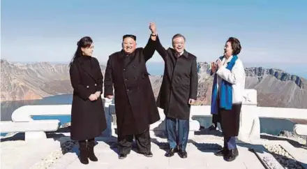  ?? PIC REUTERS ?? North Korean leader Kim Jong-un and South Korean President Moon Jae-in at the top of Mount Paektu, North Korea, yesterday. With them are Kim’s wife, Ri Sol-ju, and Moon’s wife, Kim Jung-sook.
