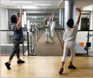  ?? AP PHOTO BY TOM SAMPSON ?? Violinist Anthony Hyatt leads dancers through Medstar Georgetown University Hospital in Washington on Oct. 11. Musicians and dancers are part of the Georgetown Lombardi Comprehens­ive Cancer Center’s arts and humanities program.