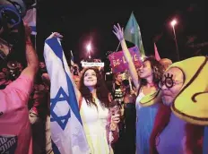  ?? Reuters ?? ■
Israelis celebrate the swearing-in of the new government in Jerusalem last night after the close Knesset vote.