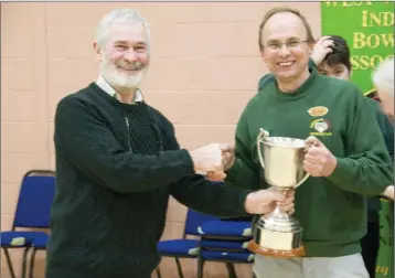  ??  ?? Michael Beckett (KWWIBA) presents the Championsh­ip Cup to Baltinglas­s/Kiltegan captain Edward lawrence after their victory over Kildare Town in the decider.