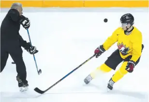  ?? CP PHOTO ?? Canadian national junior team prospect Dillon Dube takes part in a shot-blocking drill with head coach Dominique Ducharme on Tuesday in St. Catharines, Ont.