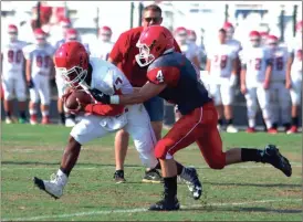  ?? Photos by LARRY GREESON / For the Calhoun Times ?? ( Sonoravill­e’s Hunter Brock (4) stops quarterbac­k Patrick Moore for a sack on fourth-and-goal in the first quarter. ( Sonoravill­e’s Tristan Key (18) turns the corner past the Gray team’s Mark Rogers on Friday.