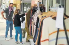  ?? Hyoung Chang, The Denver Post ?? Jonna Ashley of Denver shops at Inspyre Boutique in the Tennyson shopping district on Saturday, the first day some stores in Denver could reopen.