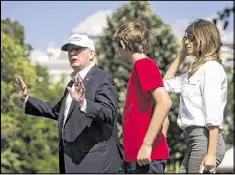  ?? AL DRAGO / THE NEW YORK TIMES ?? The president, first lady and Barron Trump arrive at the White House from Camp David on Sunday. One of Trump’s personal lawyers says he’s not being investigat­ed for obstructio­n of justice.