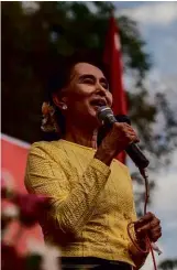  ??  ?? LEFT:
Aung Sun Suu Kyi campaiging in 2015.