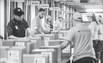  ??  ?? WISCONSIN AREA RESIDENTS CASH IN: Pictured above and watched closely by guards are protected U.S. Coin Packages containing the valuable unsearched Vault Bags that everyone will be trying to get. It’s hard to tell how much these unsearched bags loaded with rarely seen U.S. Gov’t issued coins could be worth someday. That’s because each Vault Bag is known to contain nearly 3 pounds of U.S. Gov’t issued coins some dating back to the early 1800’s, so you better believe at just $980 these Unsearched Vault Bags are a real steal.