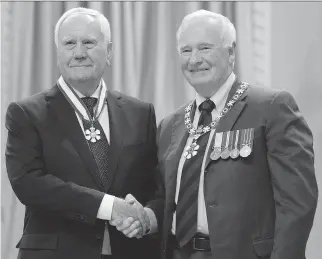  ??  ADRIAN WYLD/THE CANADIAN PRESS ?? Gov. Gen. David Johnston, right, invests 85-year-old researcher Dr. Harold Jennings, who is from Ottawa, as an officer of the Order of Canada at a ceremony at Rideau Hall on Friday.