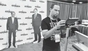  ?? Robin Jerstad ?? Brent Clingerman, of Houston, prepares the Texas Right to Life booth at the Henry B. Gonzalez Convention Center as the state Republican Convention gets underway in San Antonio.