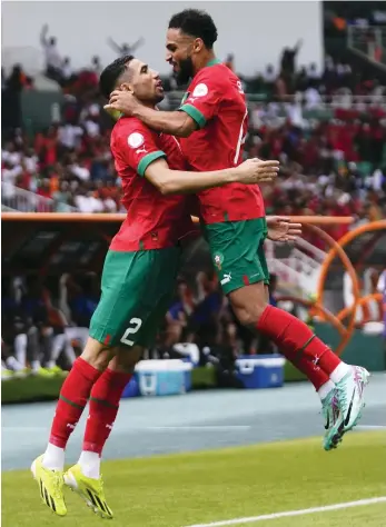  ?? AP ?? Morocco’s Achraf Hakimi, left, celebrates scoring the opening goal against DR Congo