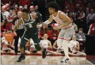  ?? JAY LAPRETE — THE ASSOCIATED PRESS ?? Michigan State’s Tyson Walker, left, dribbles past Ohio State’s Justice Sueing during the first half Feb. 12in Columbus.