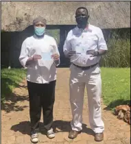  ??  ?? Victoria Falls Safari Lodge estate general manager Anlad Musonza (right) and apprentice chef Varaidzo Nguwo with their vaccinatio­n certificat­es