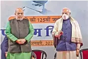  ?? — PTI ?? The hologram statue (left) of Netaji Subhas Chandra Bose at India Gate is being unveiled by Prime Minister Narendra Modi (right) as Union home minister Amit Shah looks on, in New Delhi on Monday. ■ More reports on Page 7