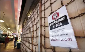  ?? ELAINE THOMPSON — THE ASSOCIATED PRESS ?? Business closures across the country, like this shop in the Pike Place Market in Seattle, has caused record number of people to seek unemployme­nt benefits, the U.S. Labor Department reported Thursday.