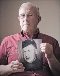  ?? MATHEW MCCARTHY WATERLOO REGION RECORD ?? Ken Weitzel, 70, holds a photograph of his uncle, Francis Weitzel, a soldier who is being honoured in France on May 5 for his sacrifice in helping to liberate the village of Buron in 1944.