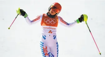  ?? Roberto Schmidt / AFP / Getty Images ?? American skier Mikaela Shiffrin reacts after falling short of a medal in the slalom, which was won by Frida Hansdotter of Sweden (right), at the Jeongseon Alpine Center. Before her first run, Shiffrin threw up before stepping into the starting gate.