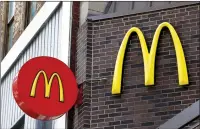  ?? AP PHOTO/KEITH SRAKOCIC ?? In this April 24 photo, corporate signage hangs at a McDonald's restaurant in downtown Pittsburgh. McDonald's Corp. reports first quarter global sales rose 4 per cent.