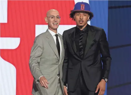  ?? BRAD PENNER/USA TODAY SPORTS ?? Oklahoma State’s Cade Cunningham, right, poses with NBA commission­er Adam Silver after being selected as the No. 1 overall pick by the Pistons in the NBA Draft Thursday at the Barclays Center in New York.
