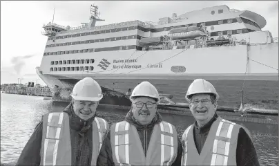  ?? SUBMITTED PHOTO ?? On a January visit to Port aux Basques, N.L., from the left, Murray Hupman, vice-president operations for Marine Atlantic, met with new board members Gary O’Brien and Owen Fitzgerald. In the background is the MV Highlander­s at dock in Port aux Basques.