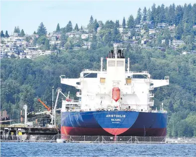  ?? JONATHAN HAYWARD / THE CANADIAN PRESS FILES ?? An oil tanker at Kinder Morgan’s Trans Mountain marine terminal, in Burnaby, B.C. In the past year, only two of the 48 tankers that entered the Westridge Dock or Parkland Burnaby terminals have departed directly for Asia.