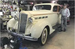  ?? DALE JOHNSON / DRIVING. CA ?? Len Schmidt in his garage with his 1937 Packard.