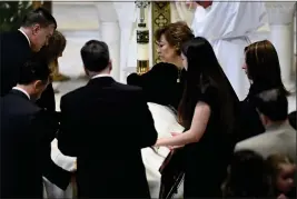  ?? PHOTOS BY TODD MCINTURF — DETROIT NEWS VIA AP ?? Family members, including mother Mary “Mia” Fraser, center right, place the pall on the casket of Brian Fraser as family members, friends and supporters gather during the funeral mass for Brian Fraser at St. Paul on the Lake Catholic Church in Grosse Pointe Farms, Mich., on Saturday.