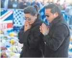  ?? Picture: PA. ?? Vichai Srivaddhan­aprabha’s son Aiyawatt and his mother Aimon lay a wreath at the ground.