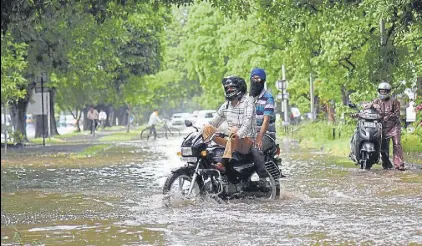  ?? HT PHOTO ?? Two-wheeler riders struggle to get through a waterlogge­d spot in Sector 9 after a heavy spell of rain in June this year.