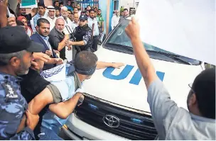  ??  ?? Hamas security officers try to prevent demonstrat­ors from blocking vehicles carrying the UN Secretary General Antonio Guterres upon his arrival at the Palestinia­n side of the Erez checkpoint in Beit Hanoun, northern Gaza Strip, yesterday.
