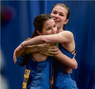  ?? ANDREW BURKE-STEVENSON FOR THE GLOBE ?? FAMILY FIRST — Sisters Daria (left) and Sasha Lamakina of Framingham celebrated after each won BAA events Saturday: Daria took the girls’ middle school 1K and Sasha ruled the girls’ scholastic mile.