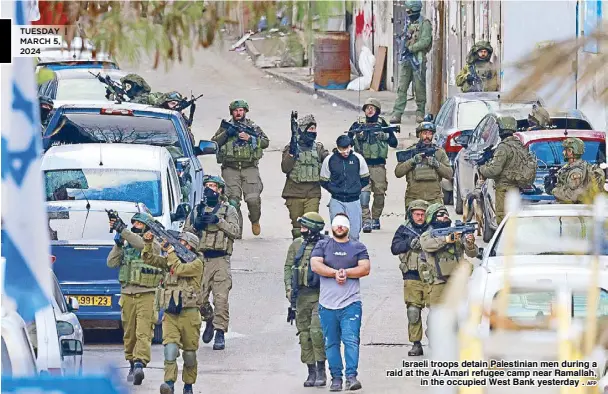  ?? AFP ?? Israeli troops detain Palestinia­n men during a raid at the Al-Amari refugee camp near Ramallah, in the occupied West Bank yesterday .