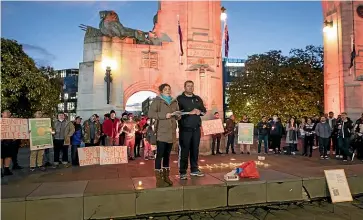  ?? STACY SQUIRES/STUFF ?? A candleligh­t gathering at Christchur­ch’s Bridge to Remembranc­e over long, stressful delays for migrants waiting for the outcome of their residency applicatio­ns.