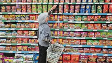  ?? — Reuters ?? Choices aplenty: A customer selecting instant noodles at a supermarke­t in Yinchuan in Ningxia Hui Autonomous Region, China.